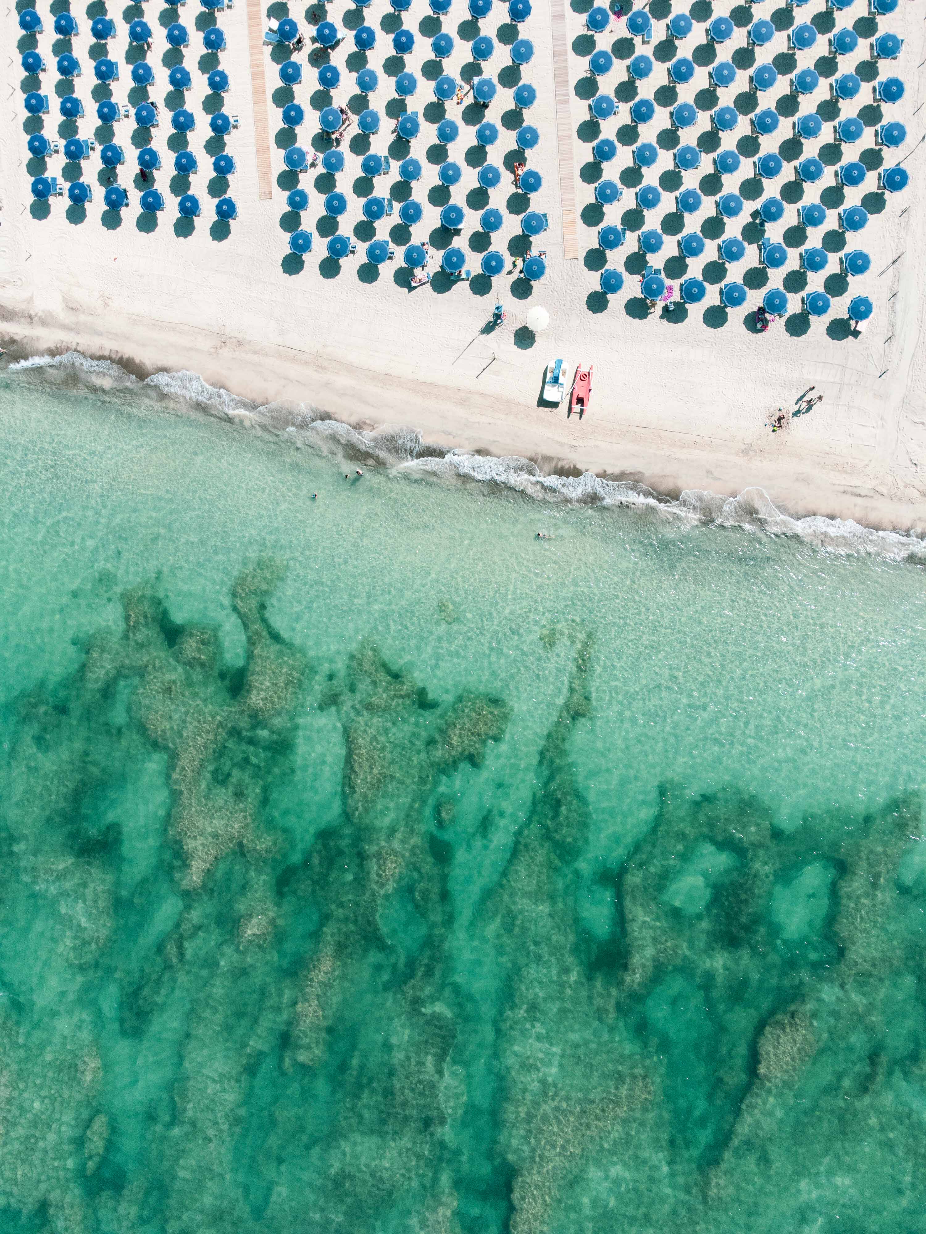 Aerial view of bathers and beach clubs at Vada White Beach on the Tuscan coast
