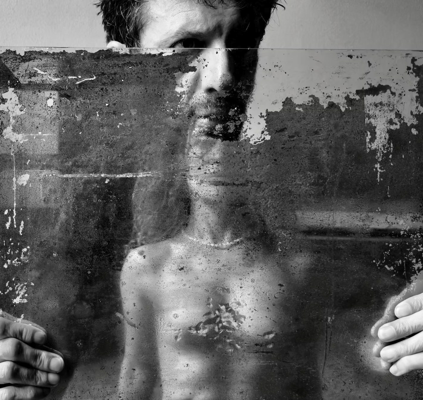 A face behind glass, in black and white, from Davide Barzaghi's LOVERS exhibition